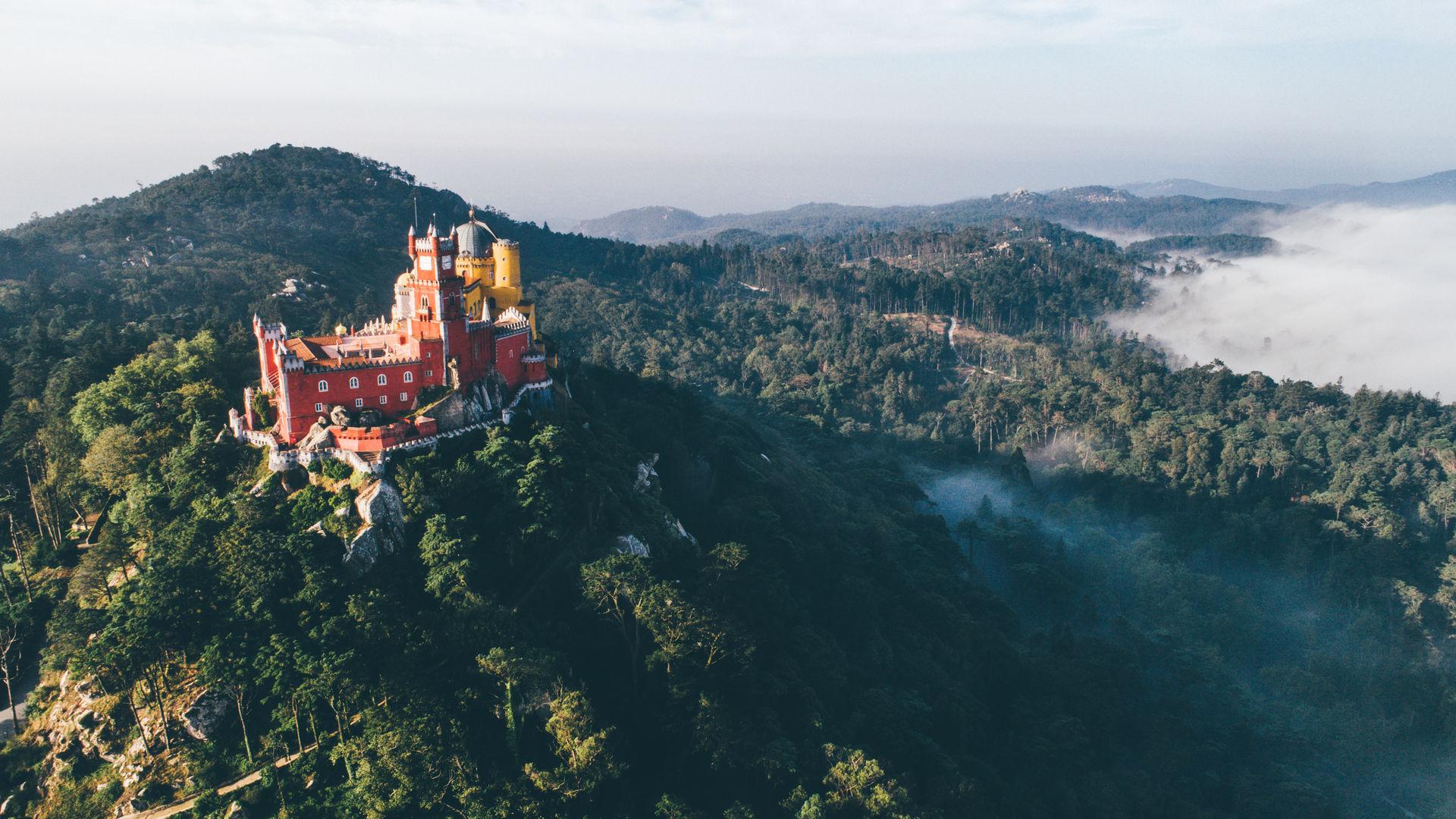 Vista aérea de Sintra ao pôr-do-sol, com a vila aninhada na encosta da serra